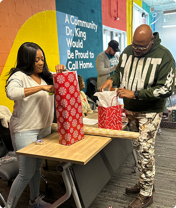 Community members wrapping gifts together