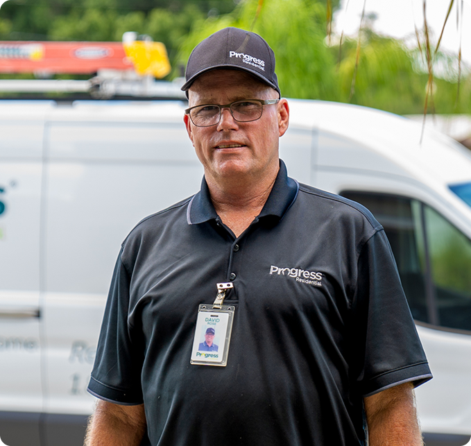 Team member standing in front of a vehicle